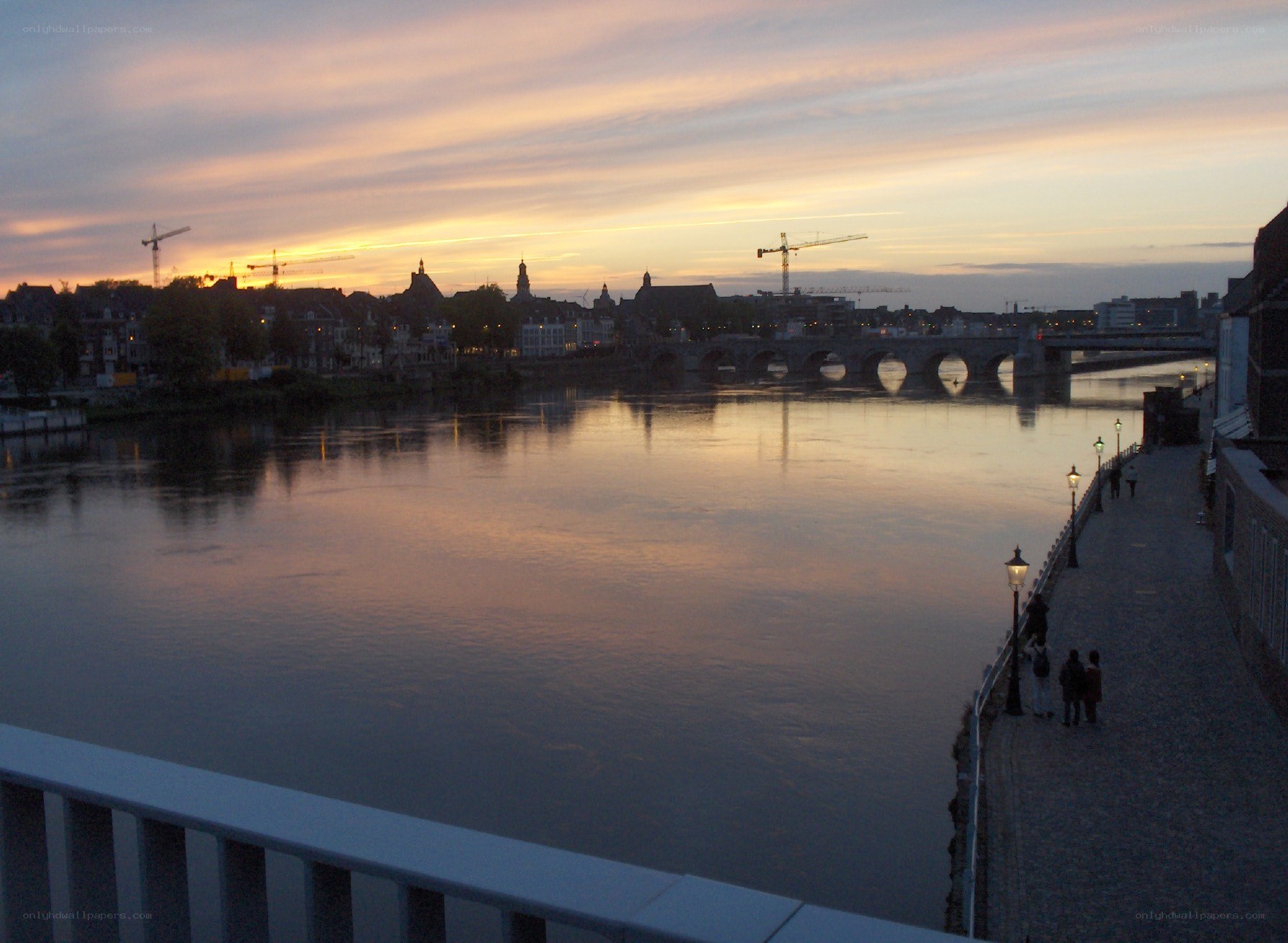sunset over river and bridge