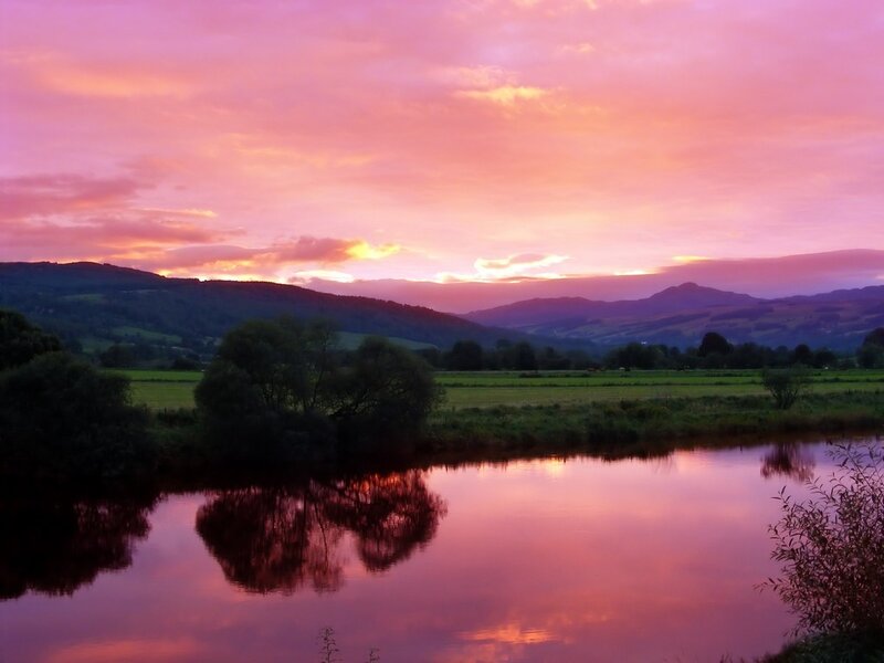 sunset over river and hills
