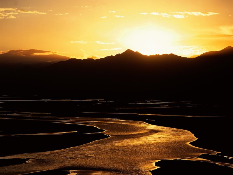 Sunset over river and mountains
