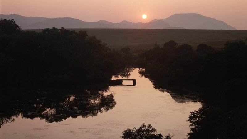 Sunset over river and mountains