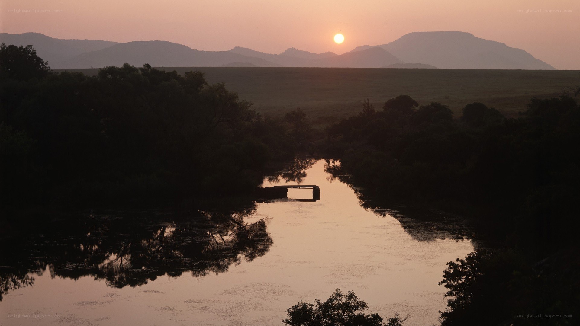 Sunset over river and mountains