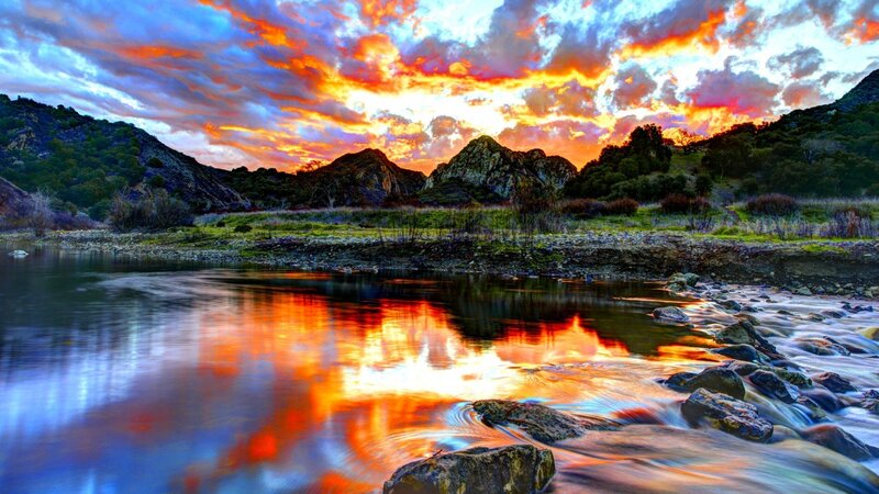 Sunset over river and mountains