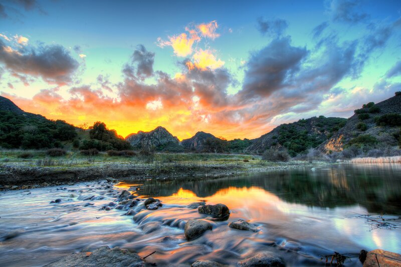 Sunset over river and mountains