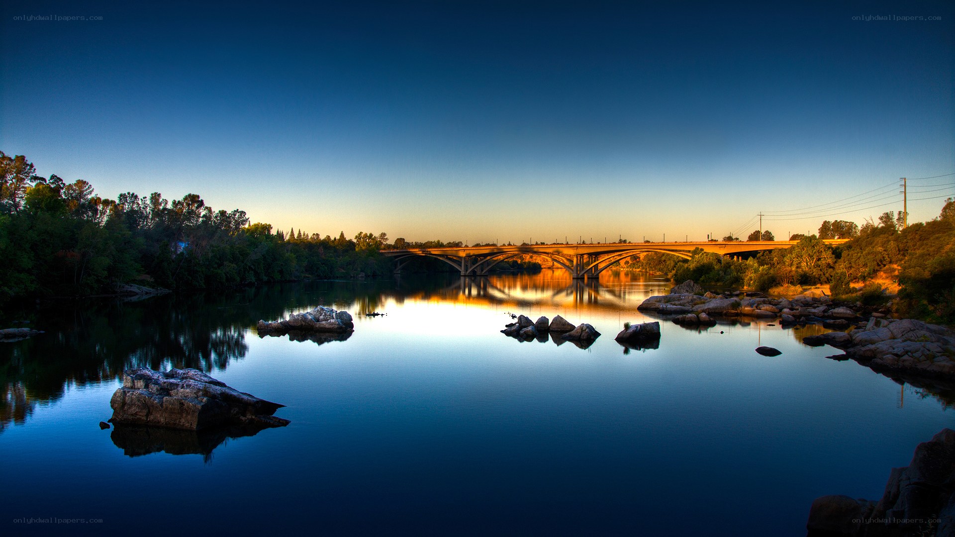 Sunset over river bridge