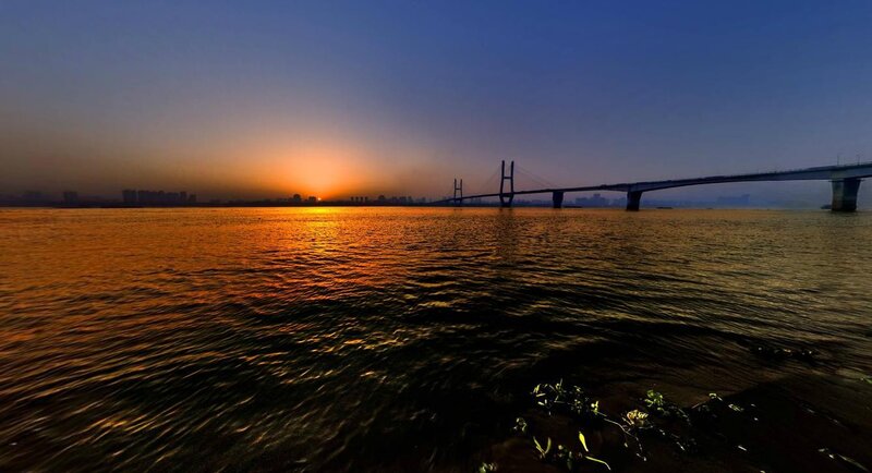 Sunset over river bridge