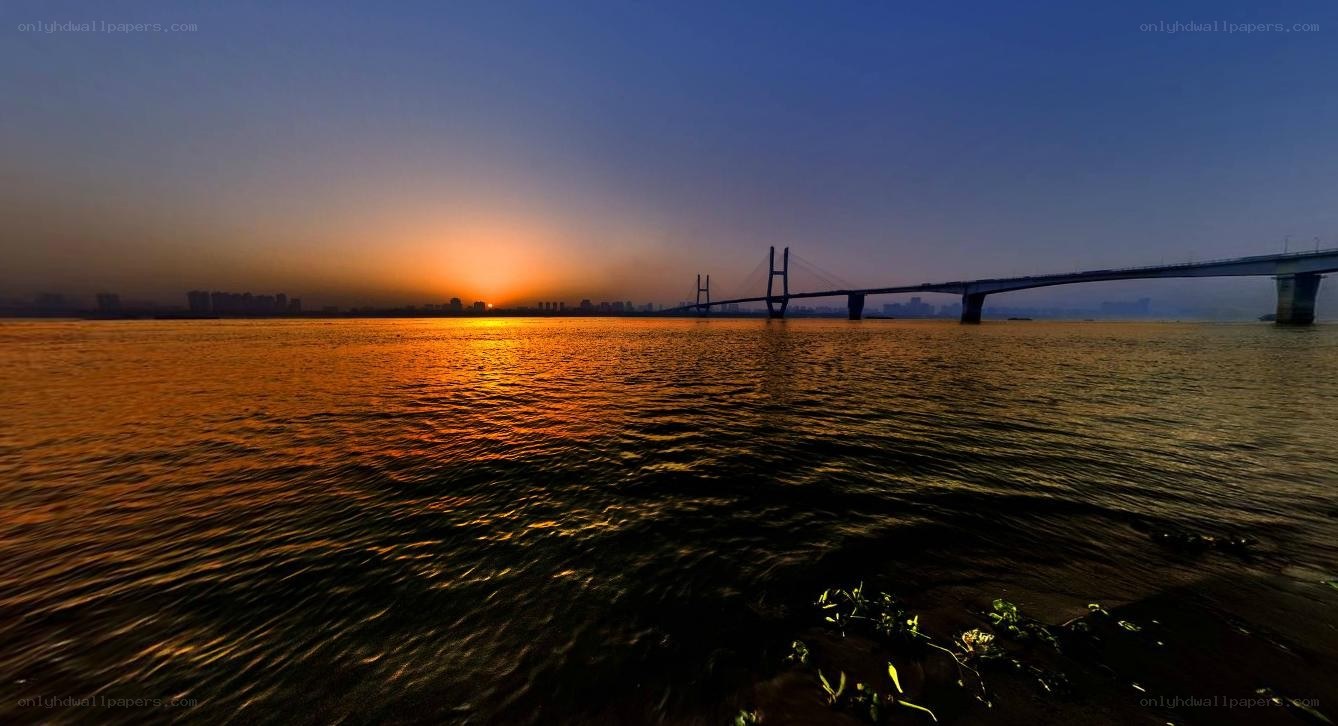 Sunset over river bridge