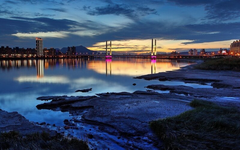 Sunset over River Bridge — Blue, Serene, Photograph, City Skyline, Mountain, Mudflat, Yellow