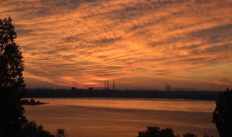 Sunset over River — Orange, Dramatic, Photograph, Trees, Industrial Skyline