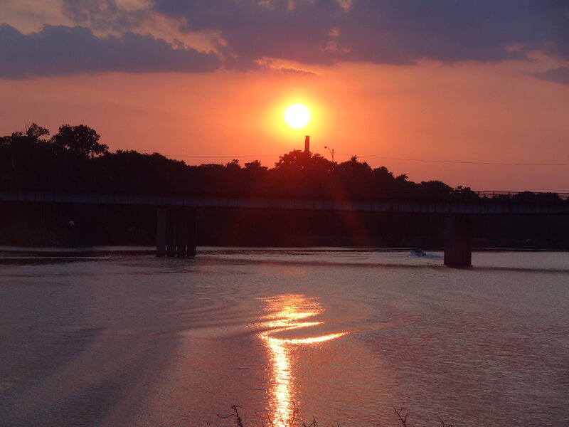 Sunset over River — Orange, Serene, Photograph, Bridge, Boat