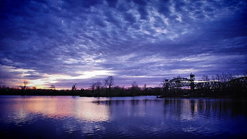 Sunset over river with bridge