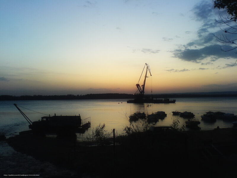Sunset over river with crane