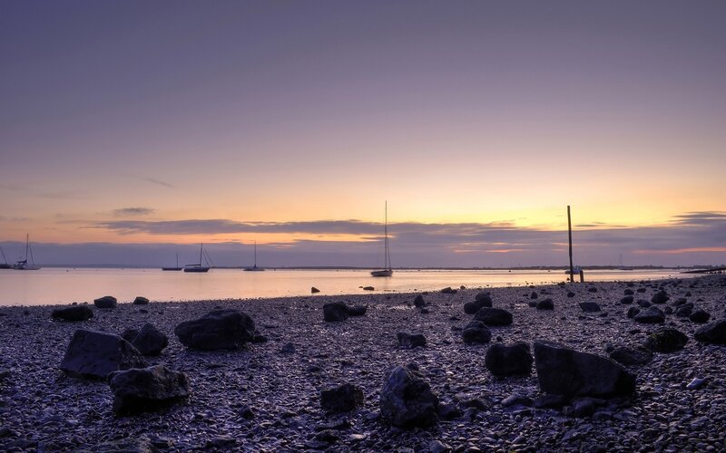 sunset over rocky beach
