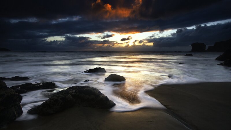 Sunset over rocky beach