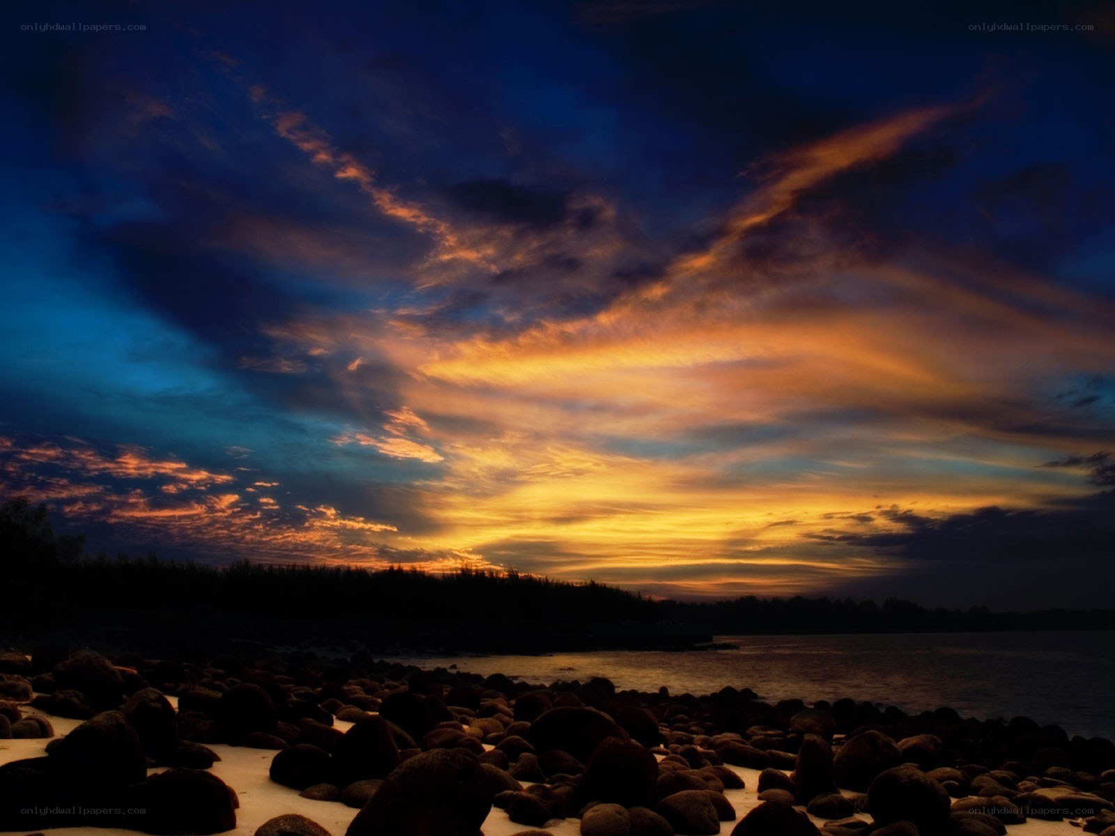 Sunset over rocky beach