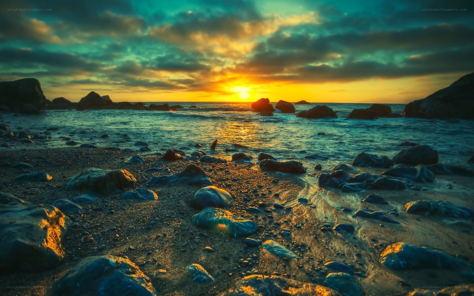 Sunset over rocky beach