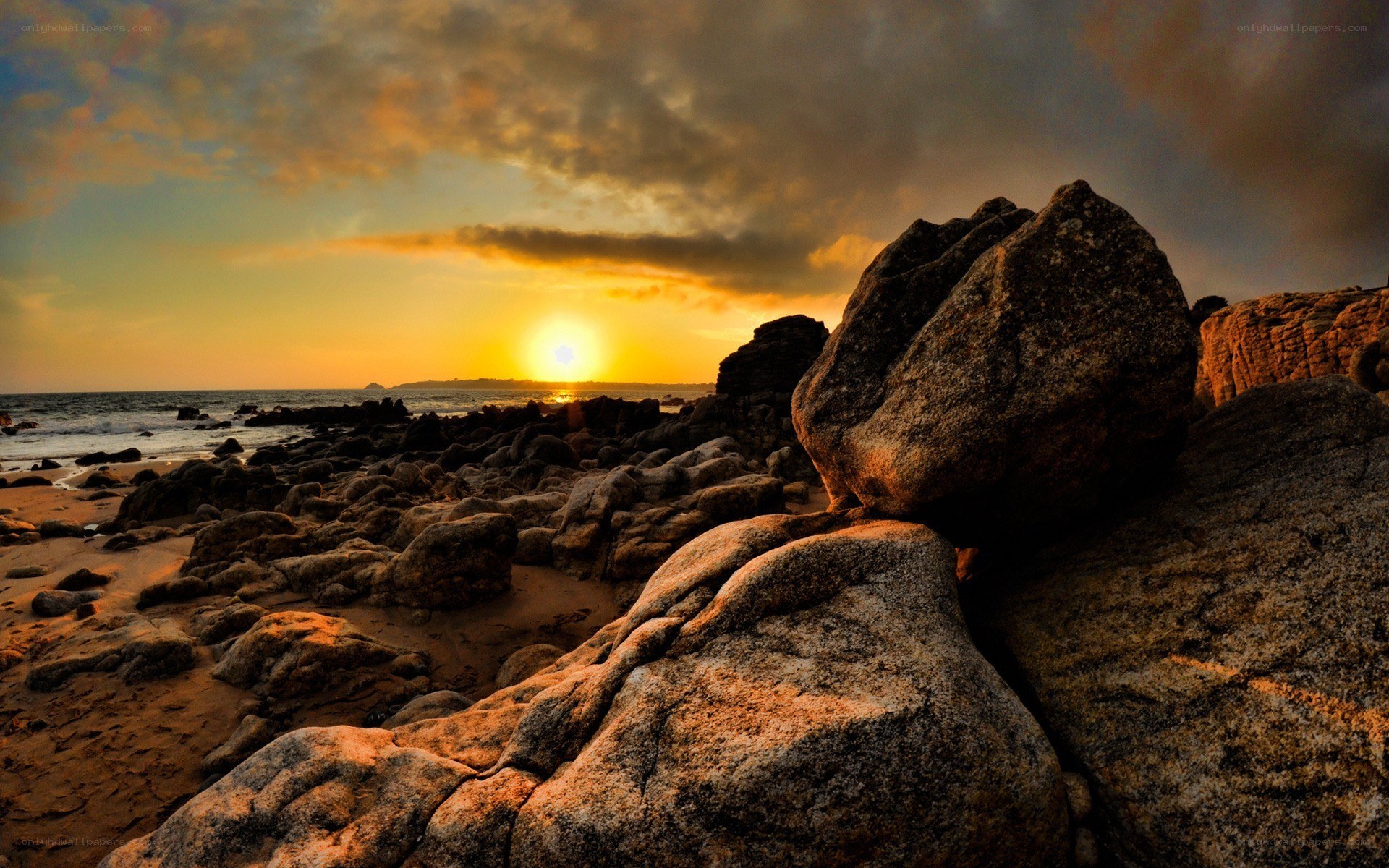 Sunset over rocky beach