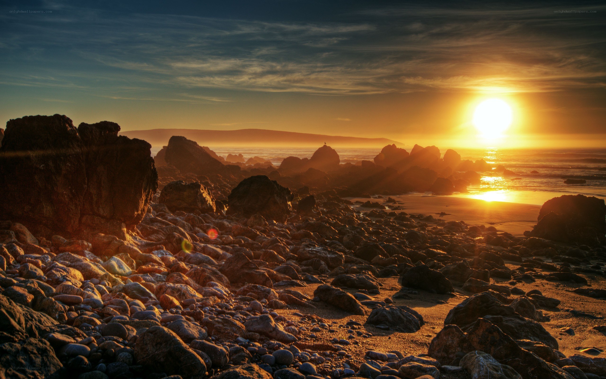 Sunset over rocky beach