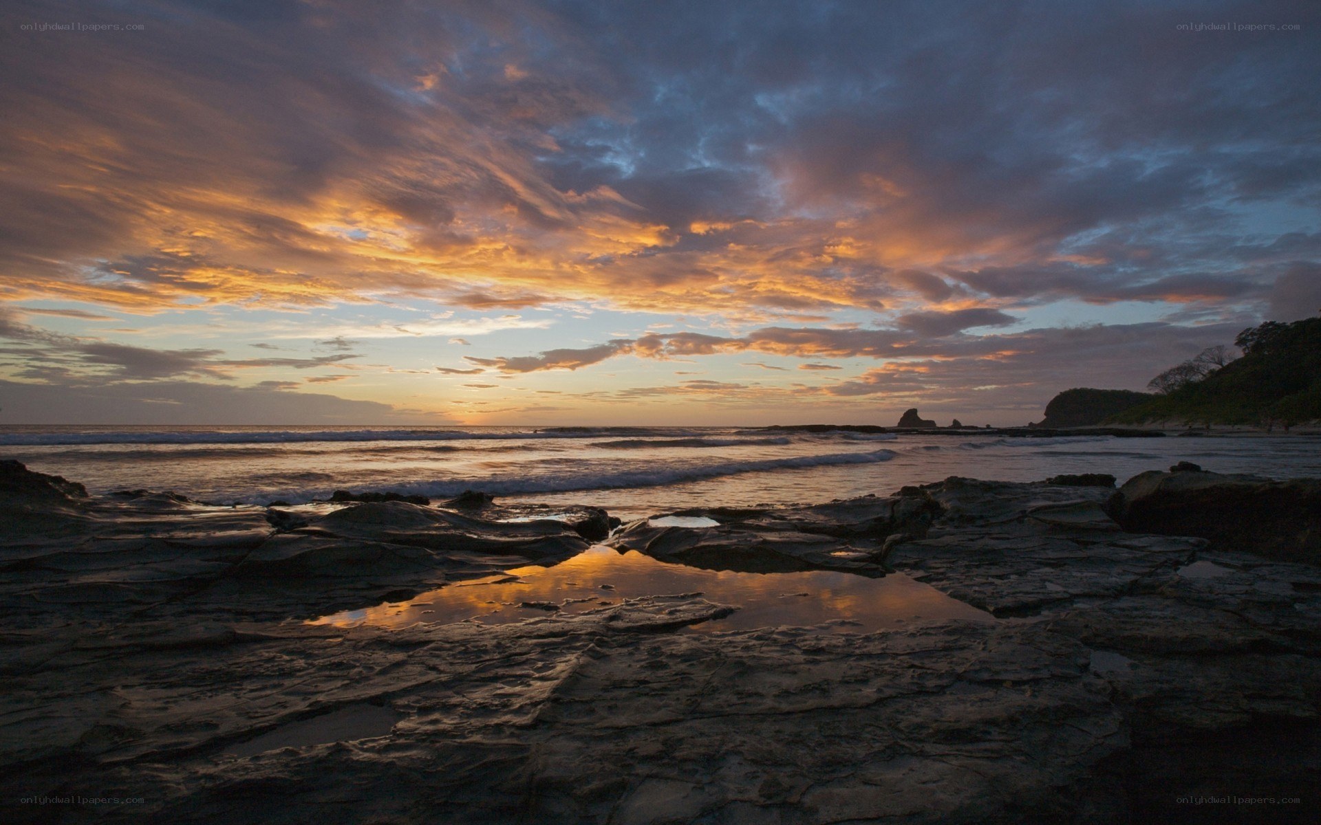 Sunset over rocky beach