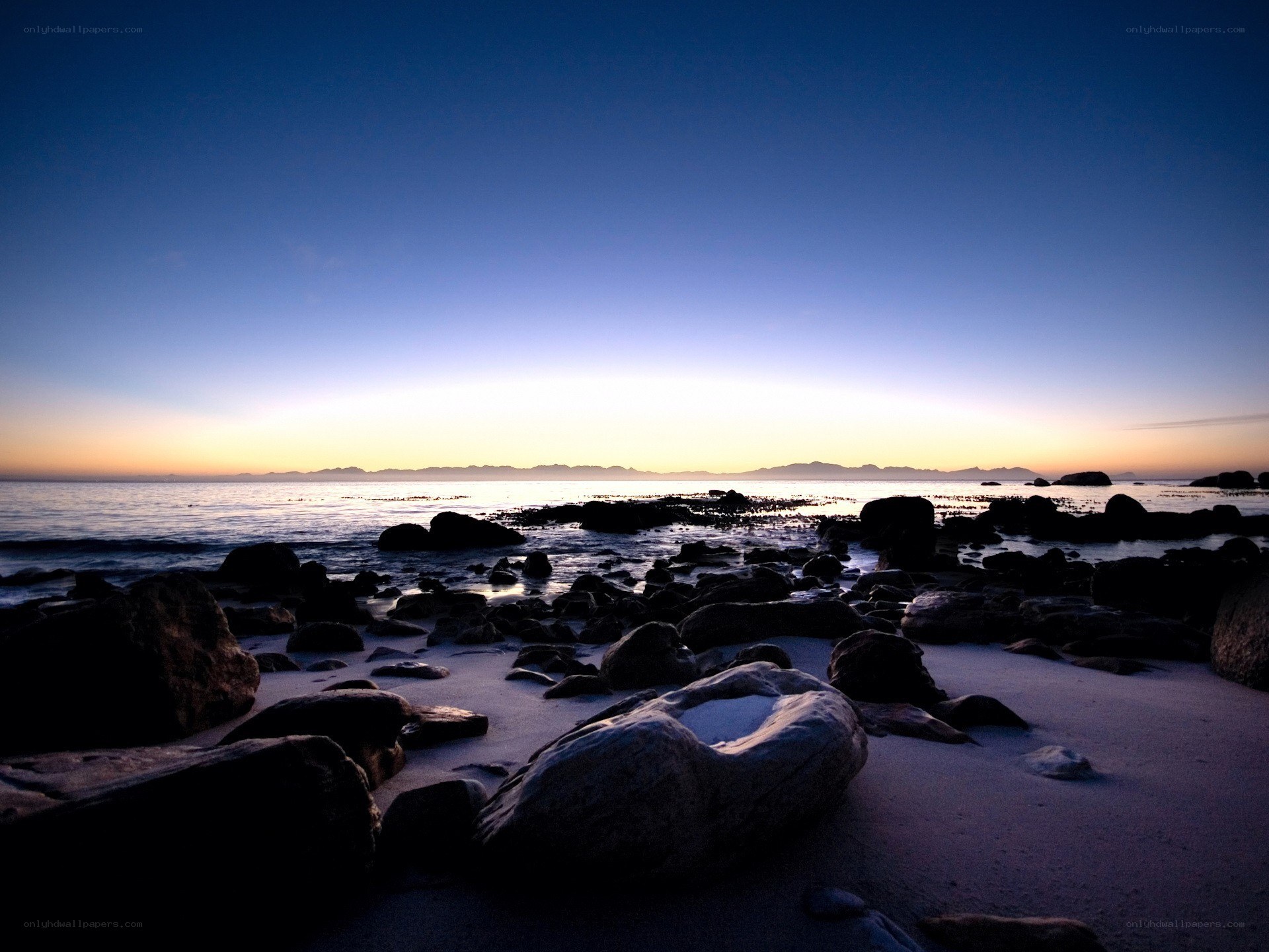 Sunset over rocky beach