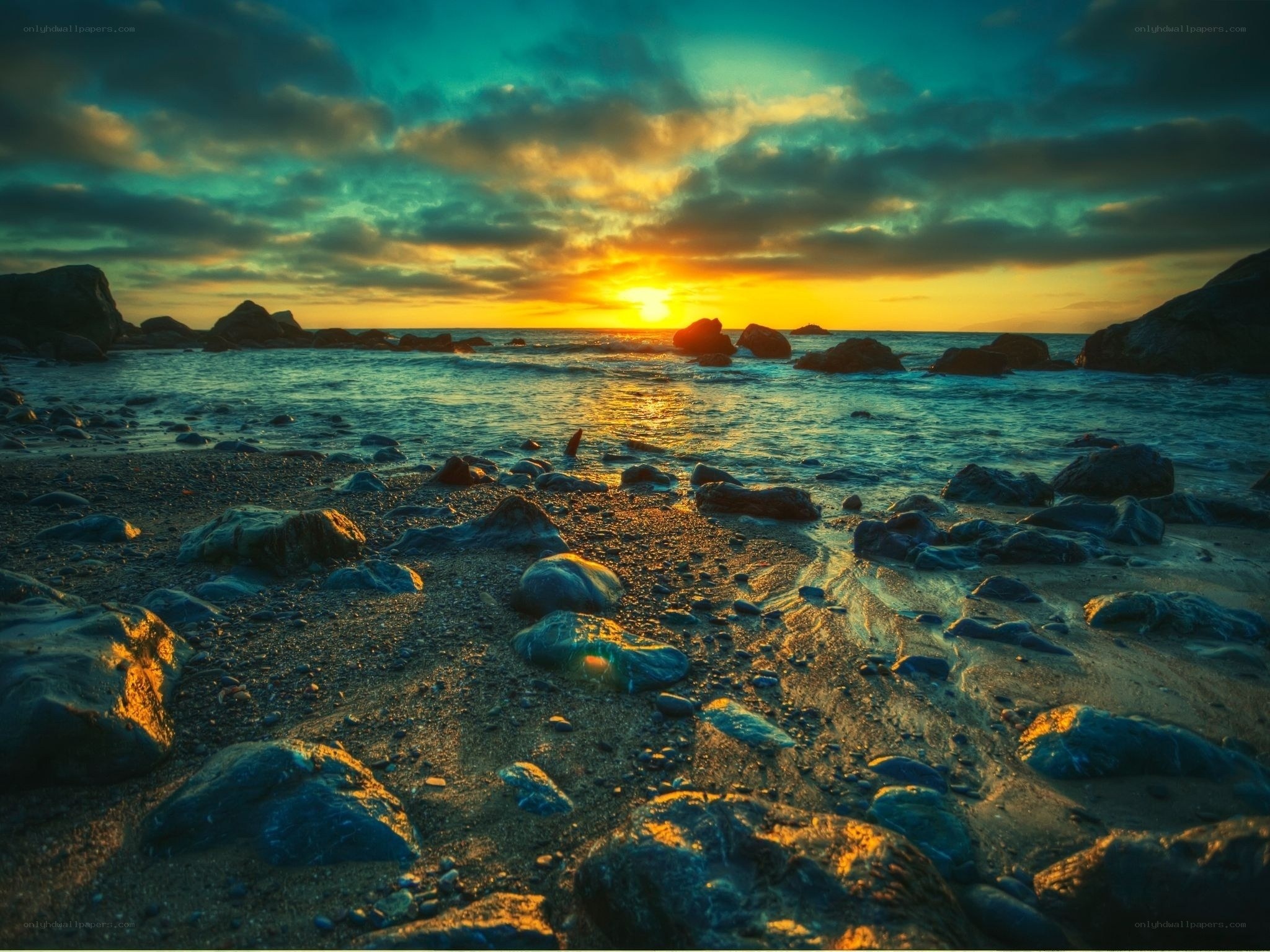 Sunset over rocky beach