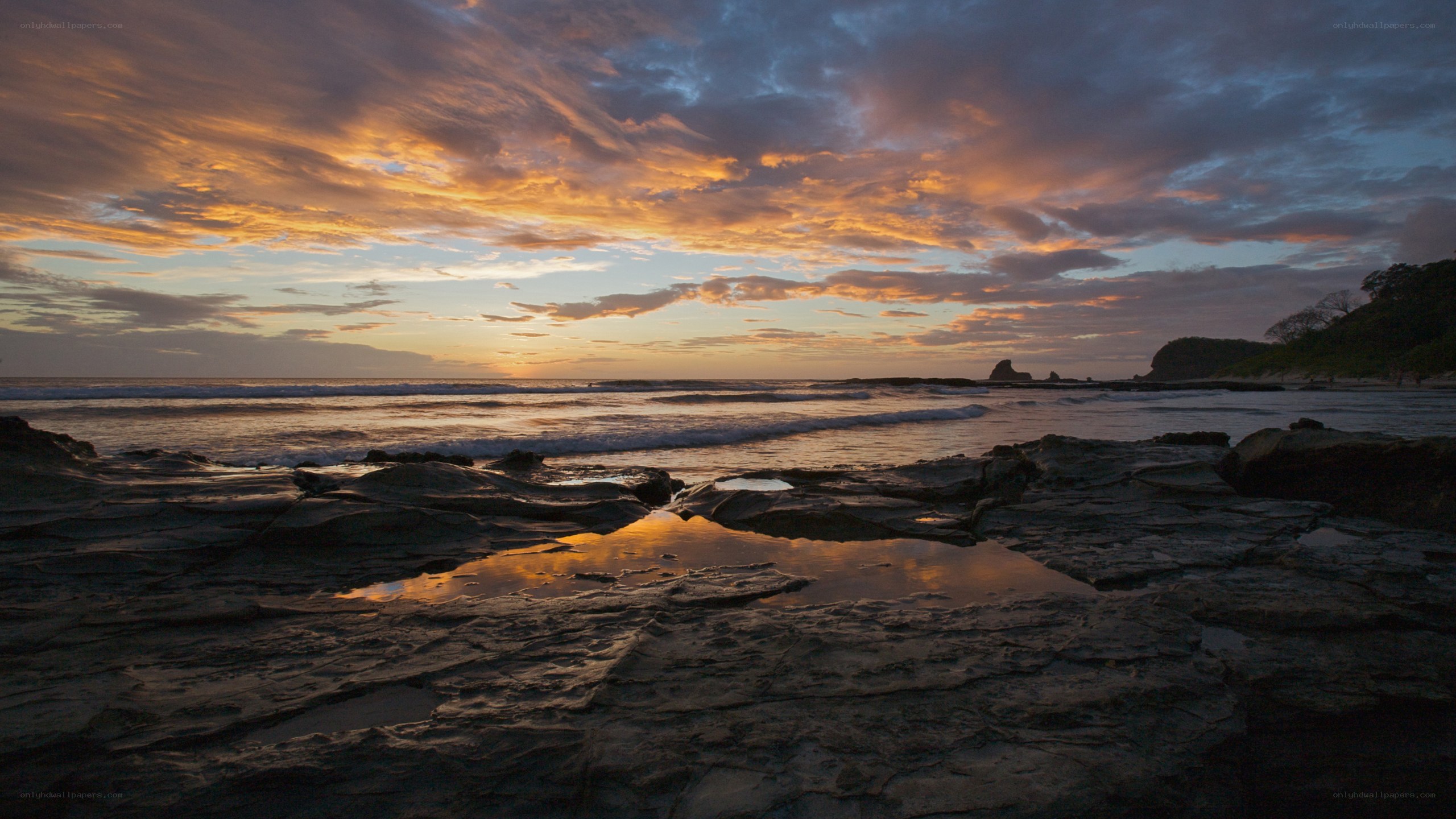 sunset over rocky beach