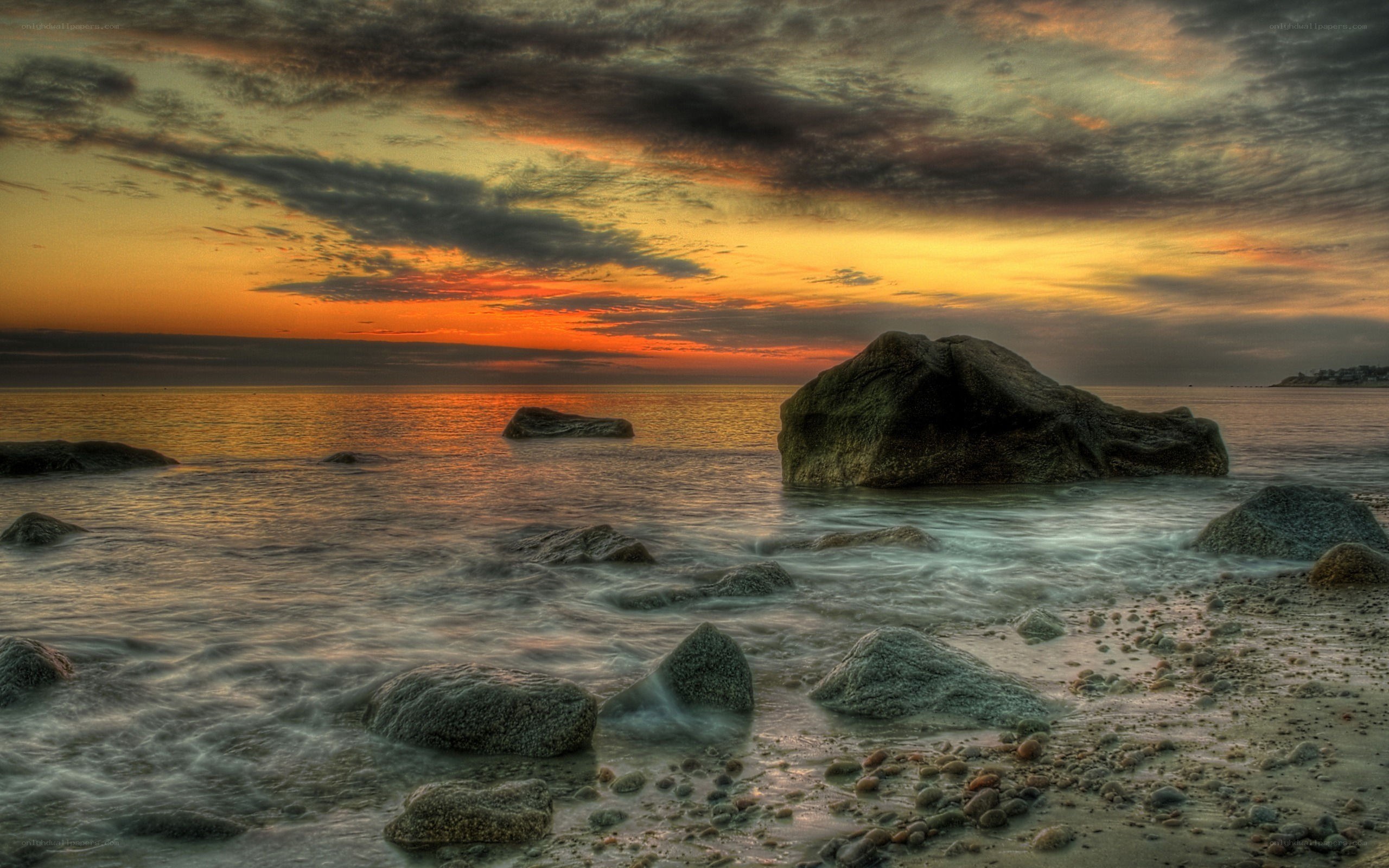 Sunset over rocky beach