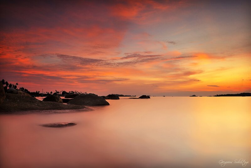 Sunset over rocky beach