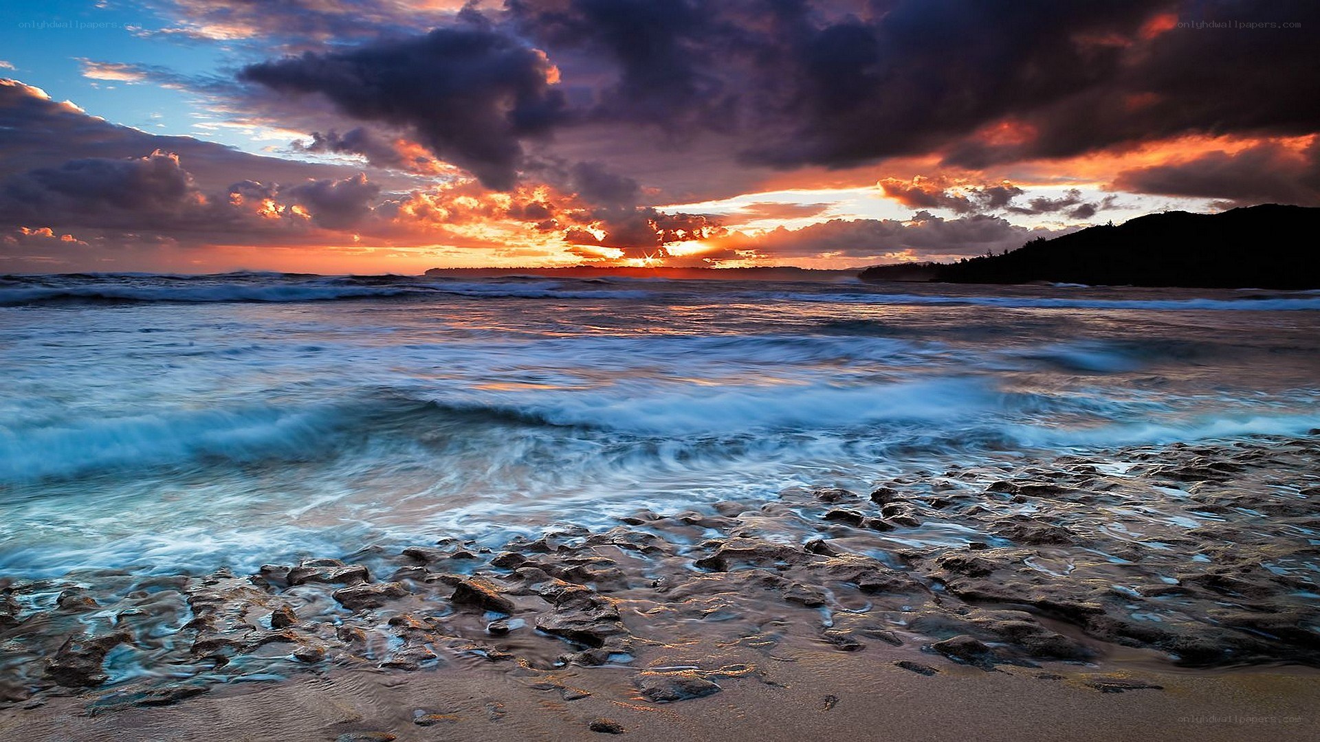 Sunset over rocky beach