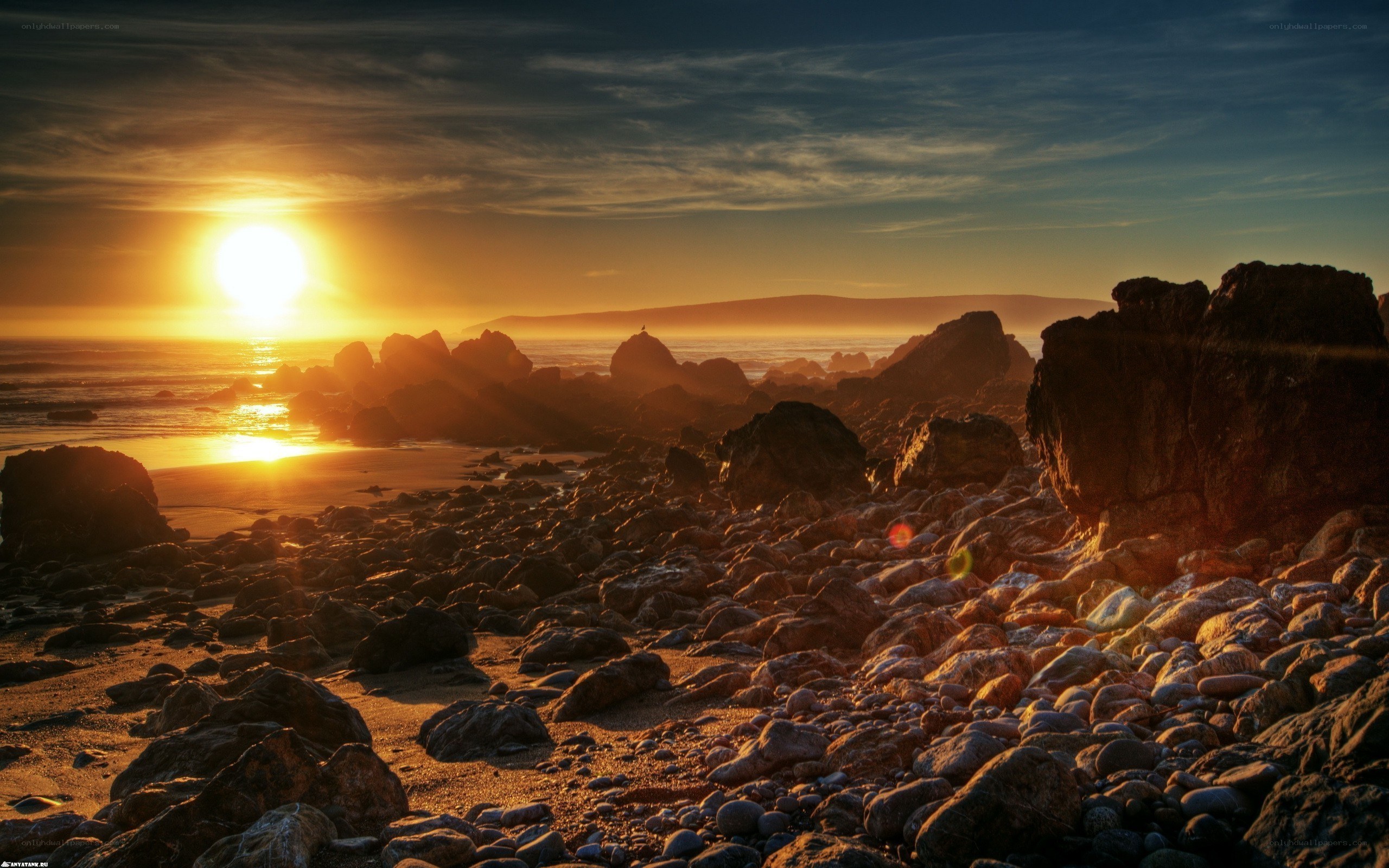 Sunset over rocky beach