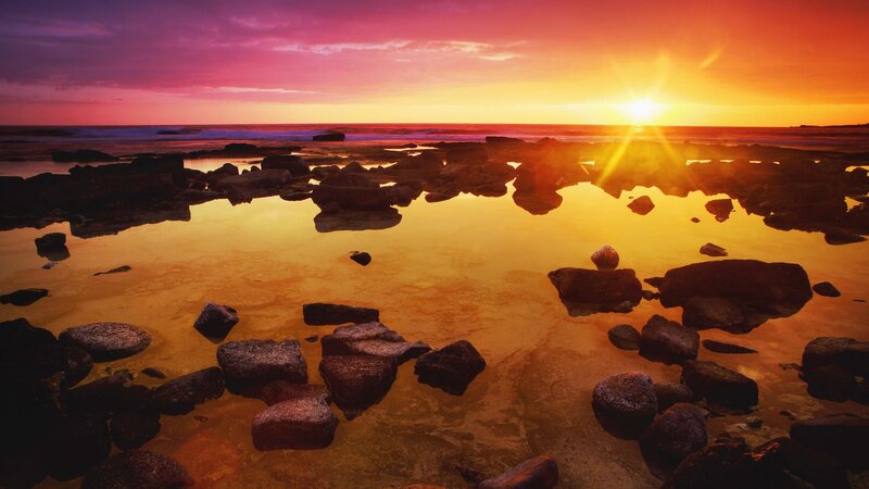 Sunset over rocky beach