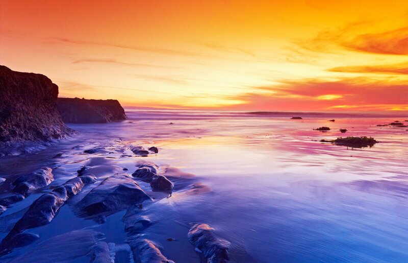 Sunset over rocky beach