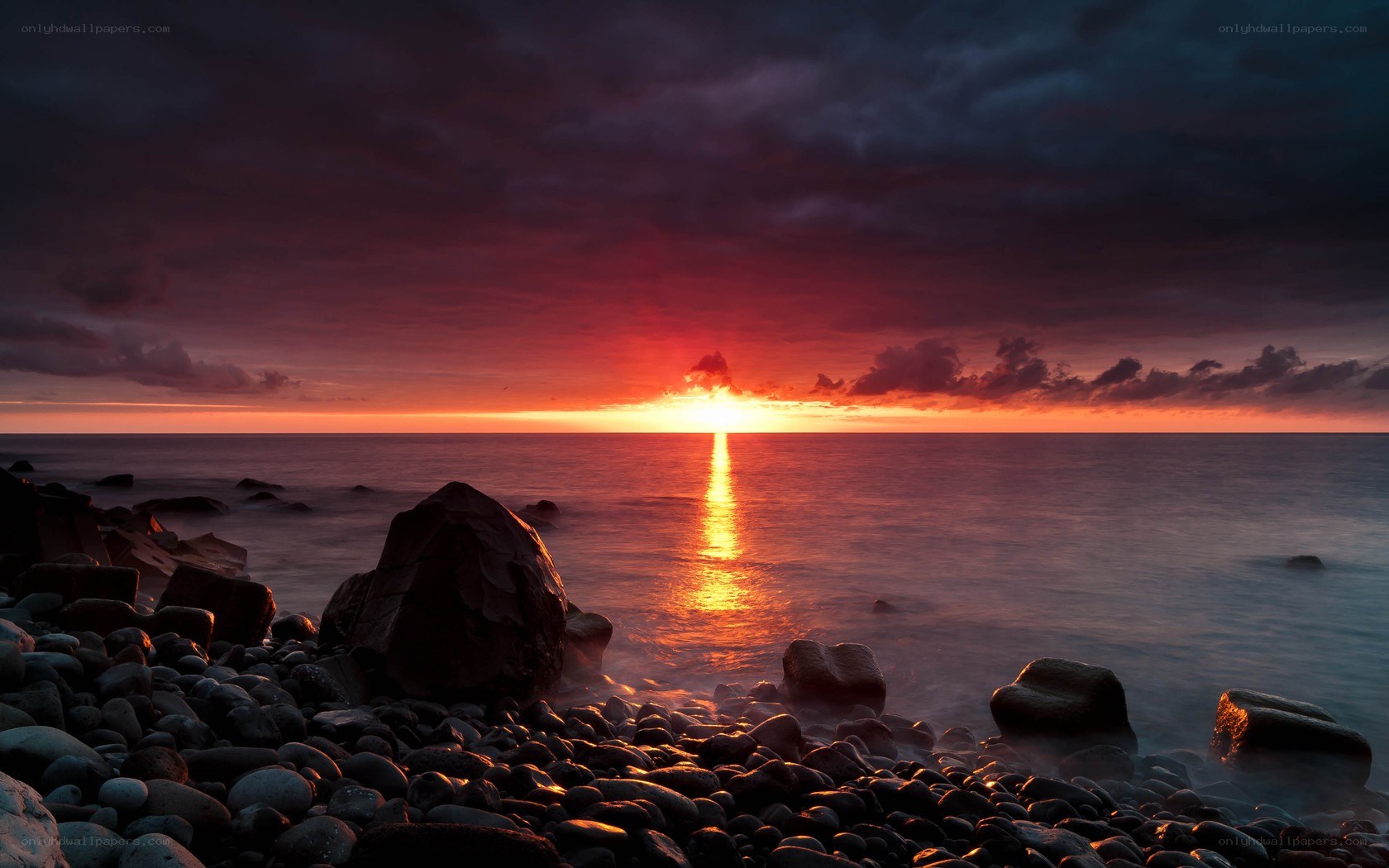 Sunset over rocky beach