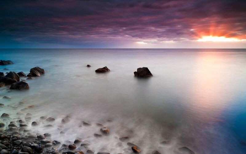 Sunset over rocky beach