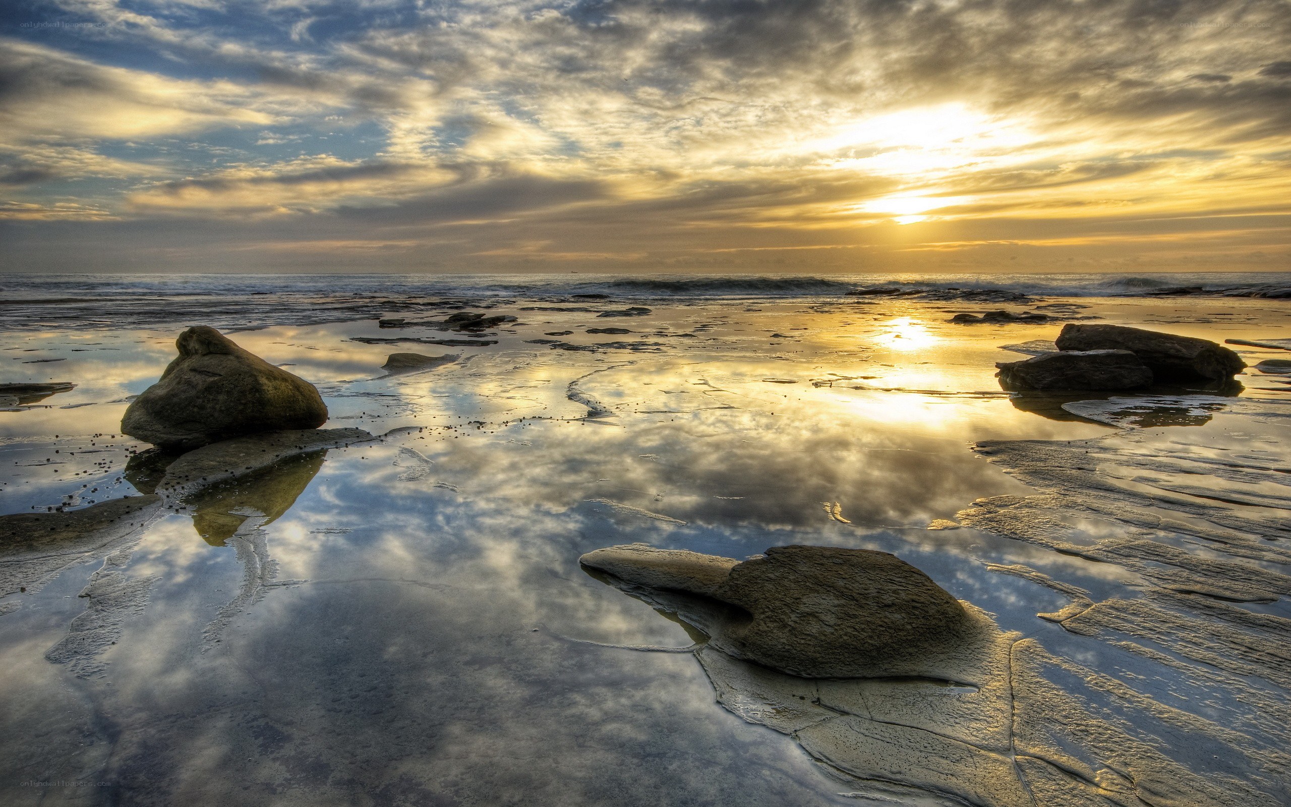 Sunset over rocky beach