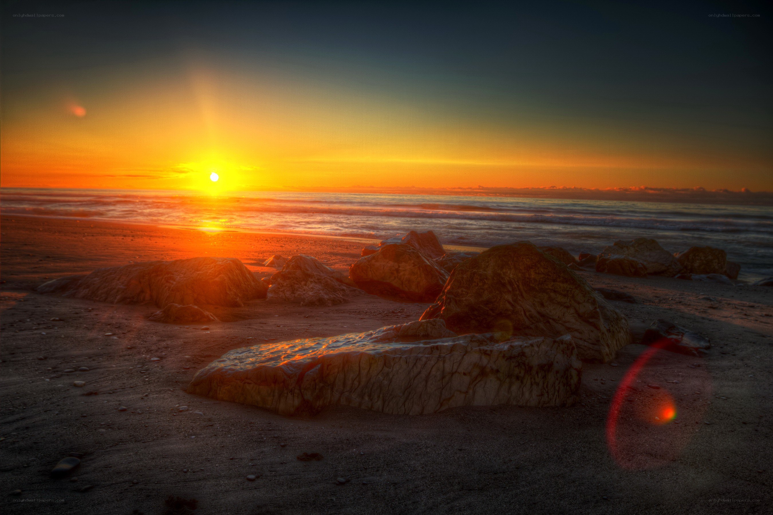 Sunset over rocky beach