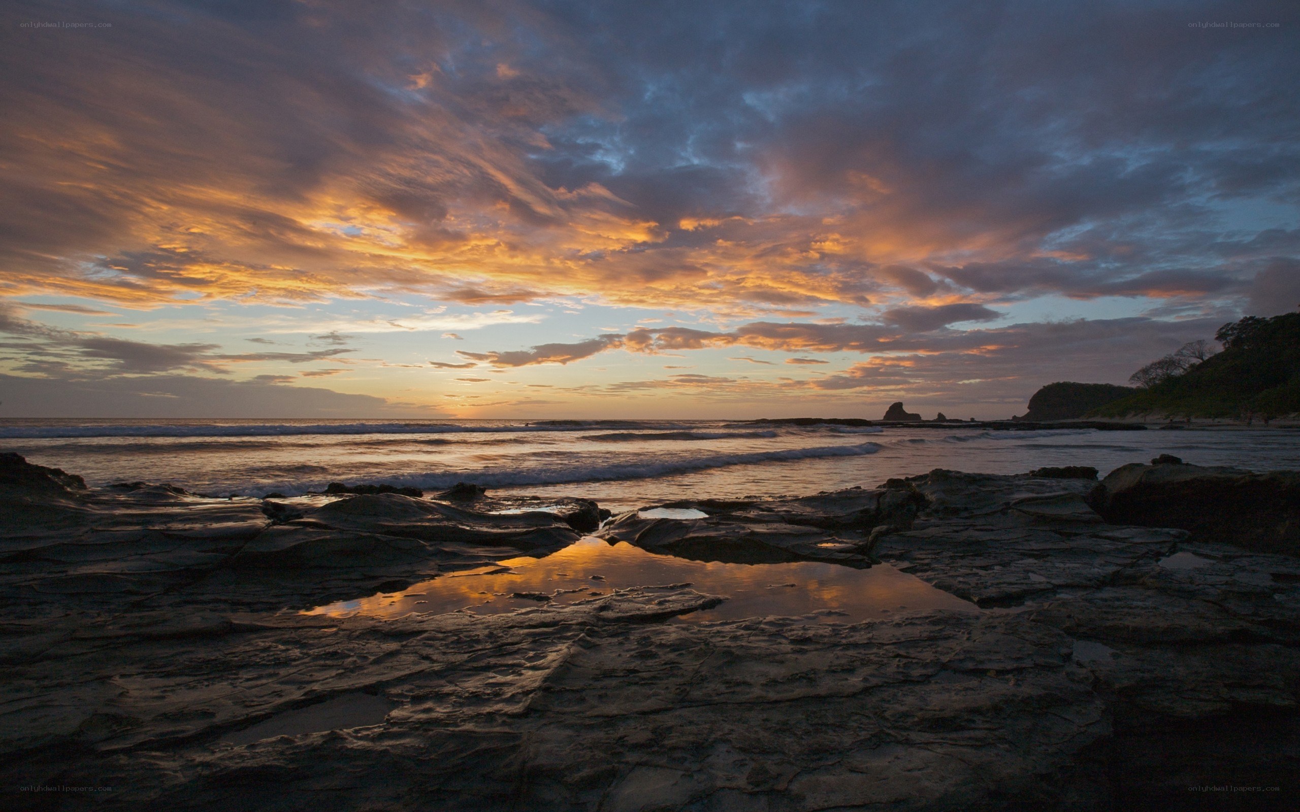 sunset over rocky beach