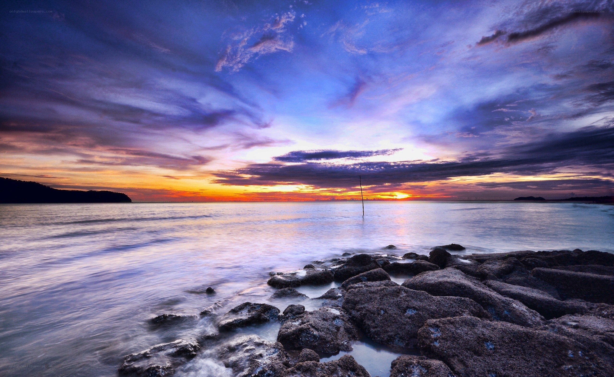Sunset over rocky beach