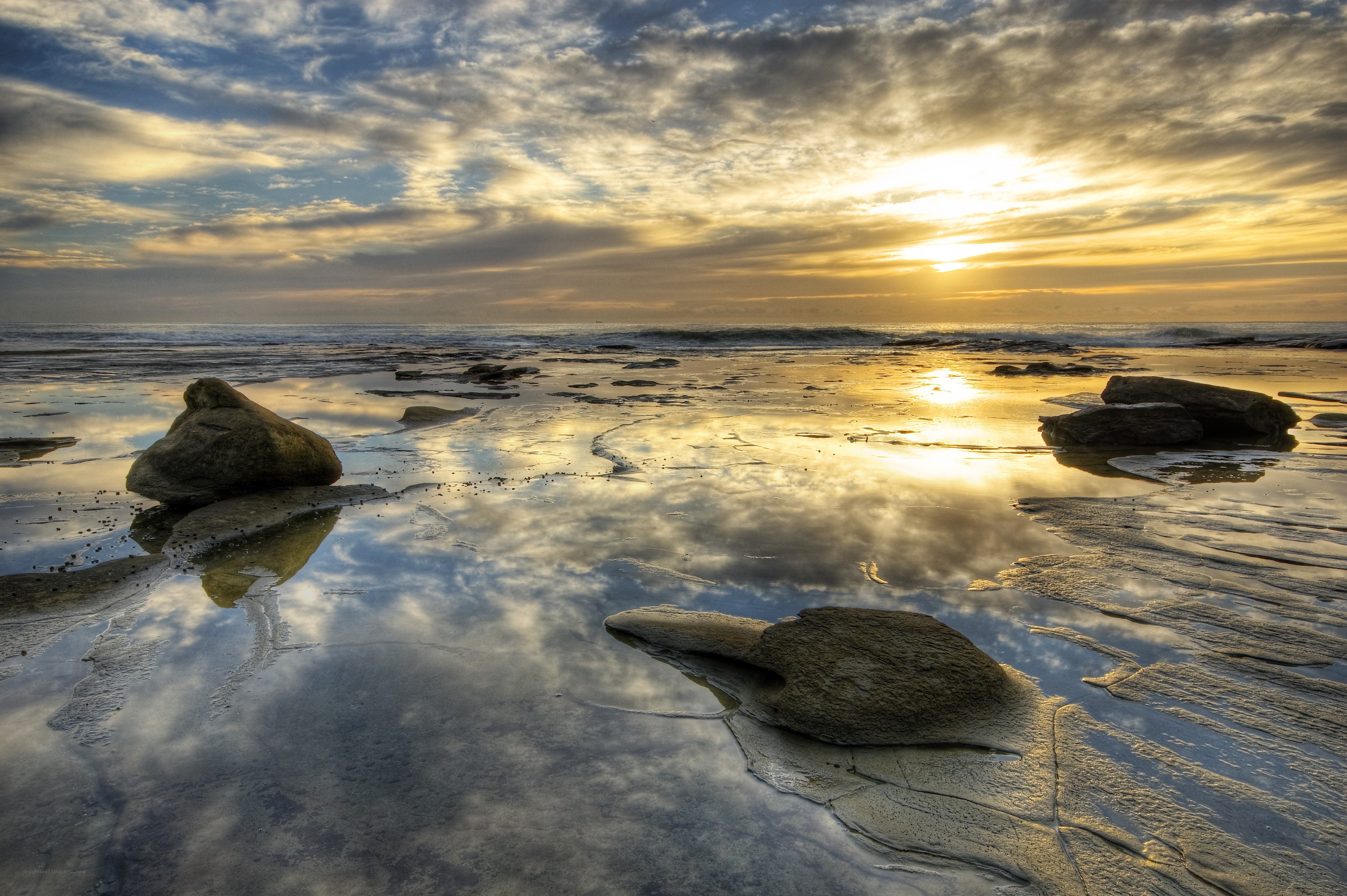 Sunset over rocky beach