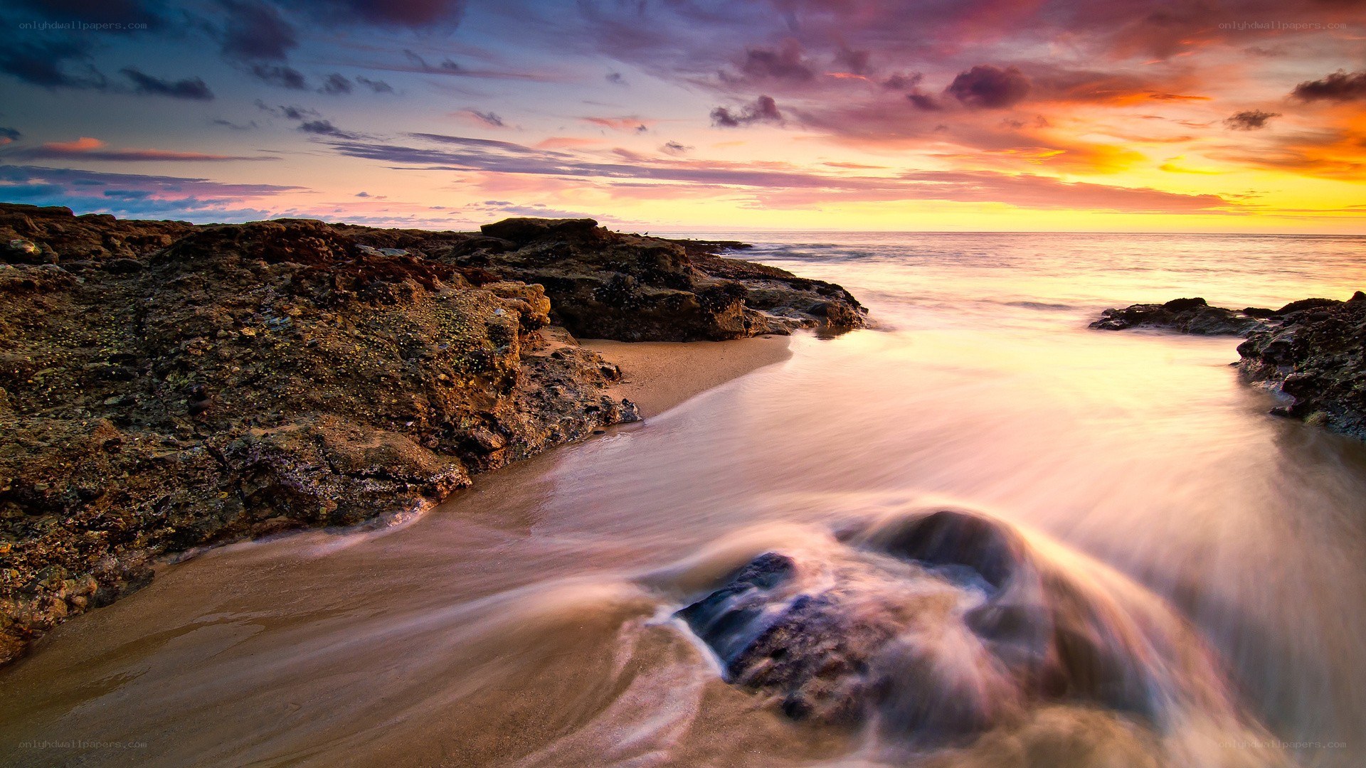 Sunset over rocky beach