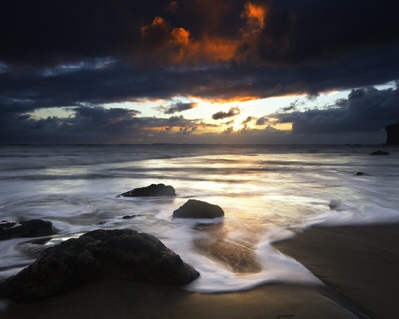 Sunset over rocky beach
