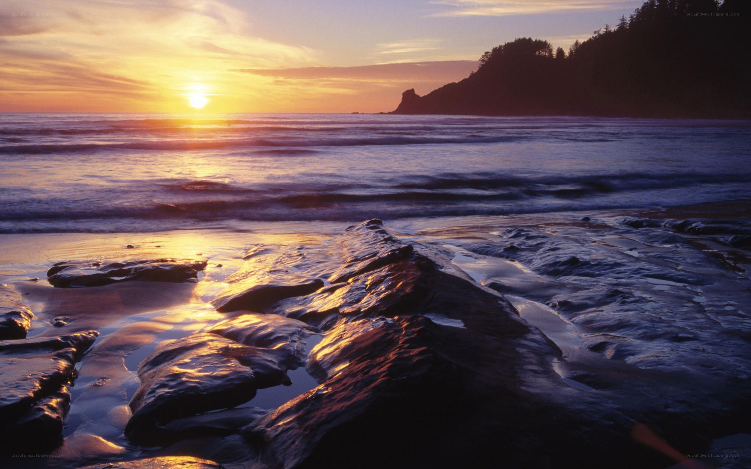 sunset over rocky beach