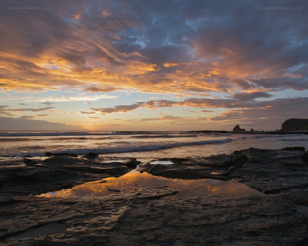 Sunset over rocky beach