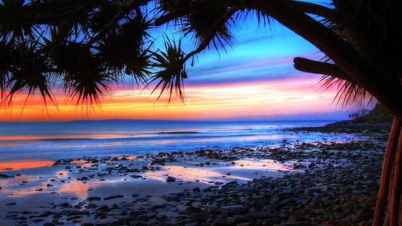 sunset over rocky beach