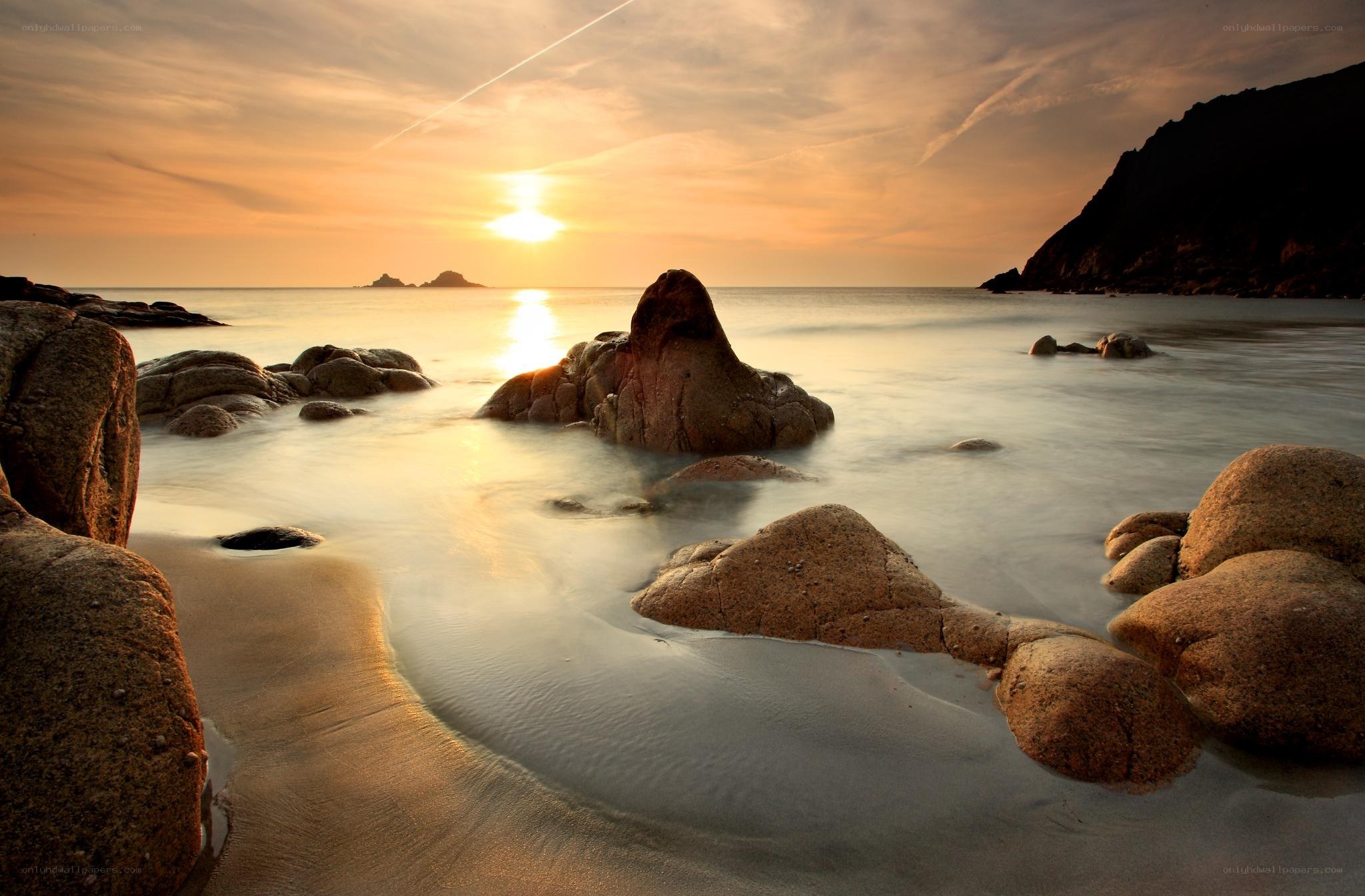 Sunset over rocky beach