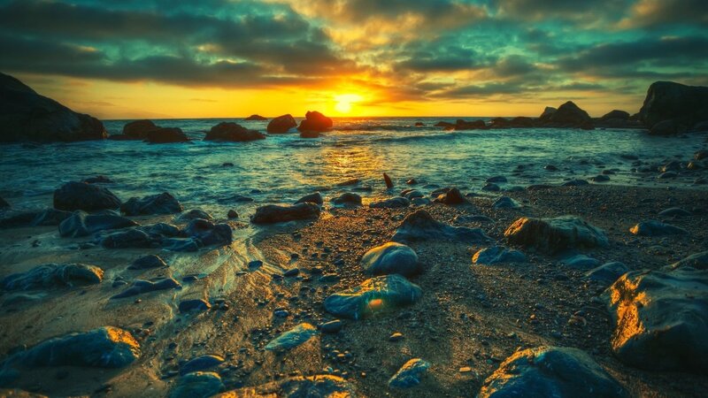 Sunset over rocky beach