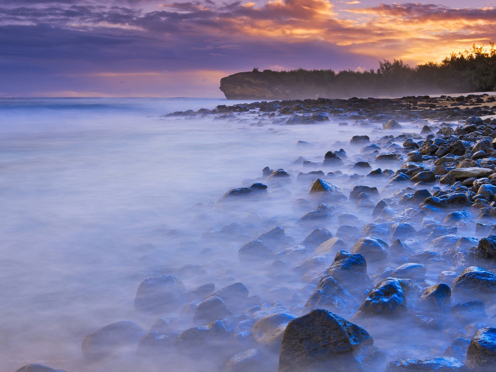 Sunset over rocky beach