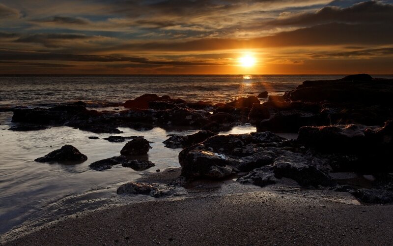 Sunset over rocky beach
