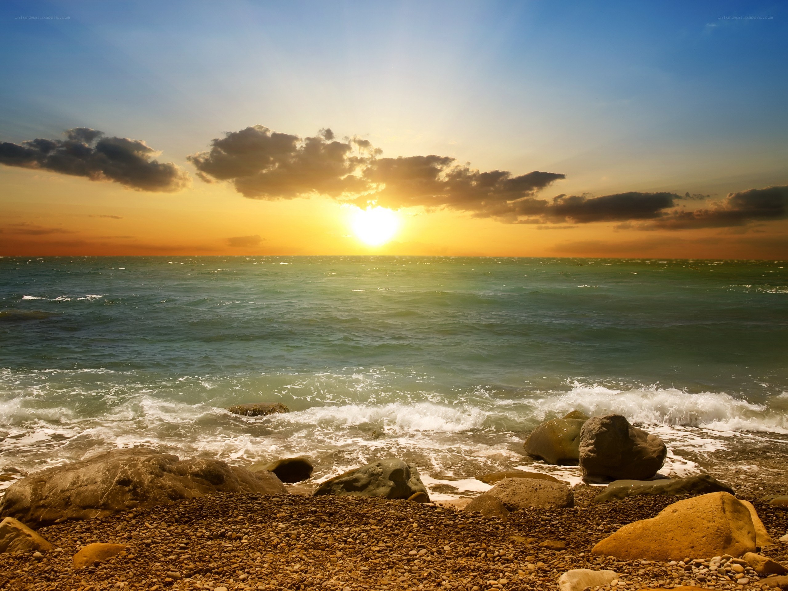 Sunset over rocky beach