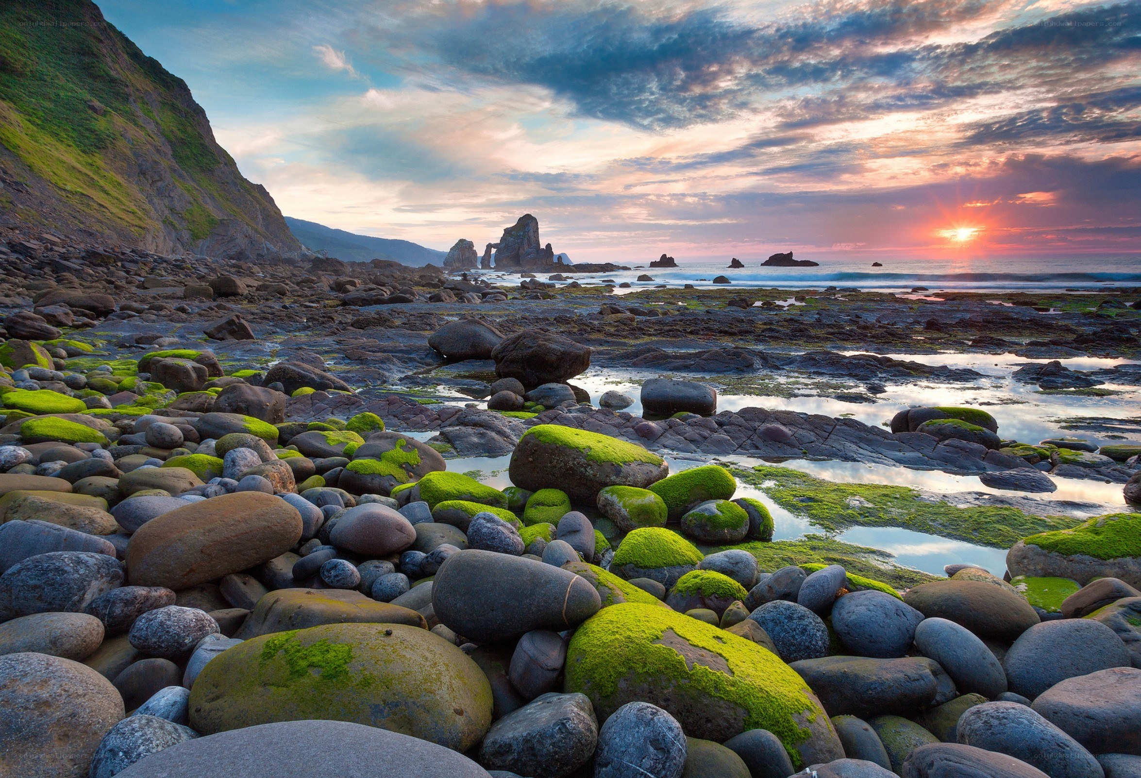 Sunset over rocky beach