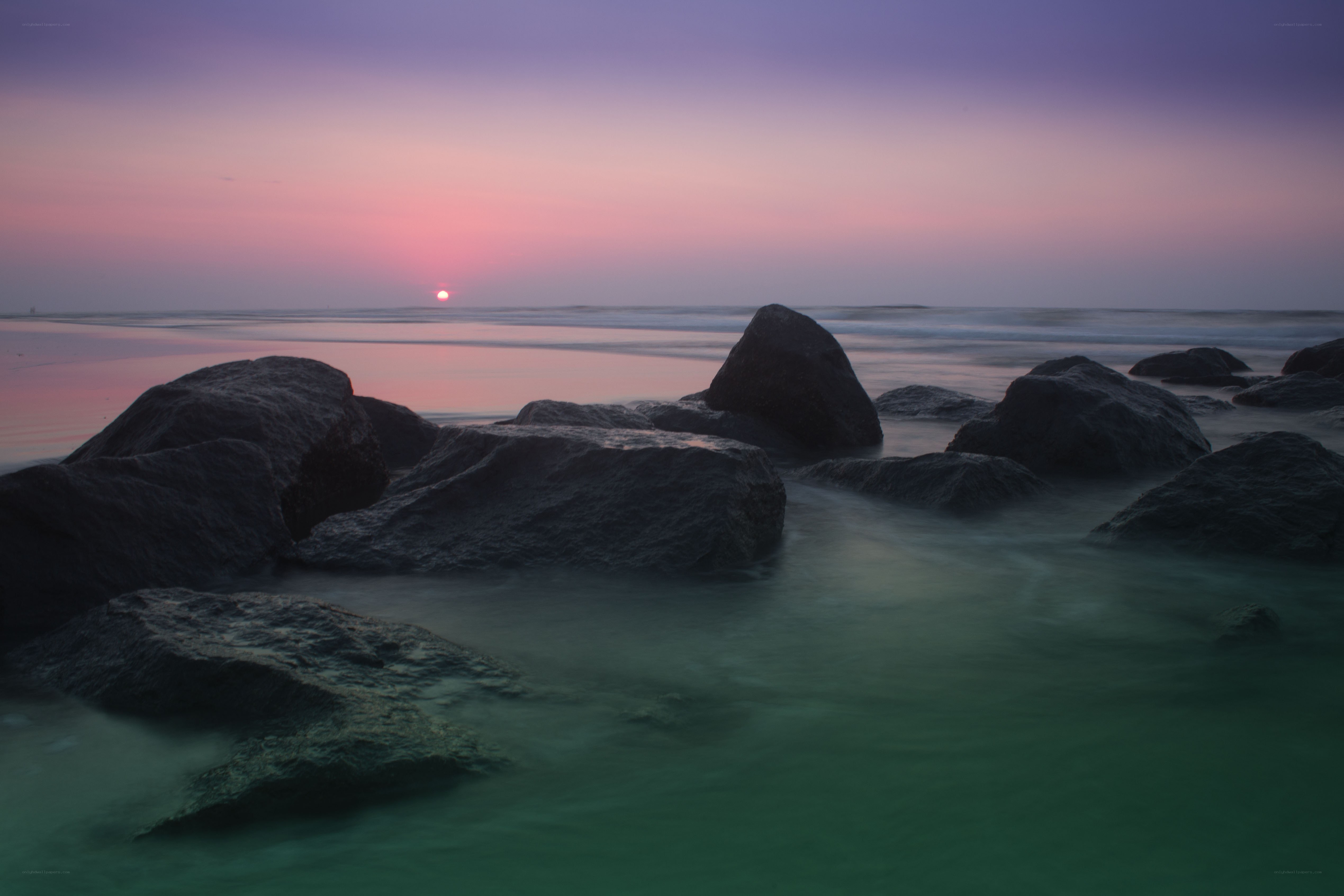 Sunset over rocky beach